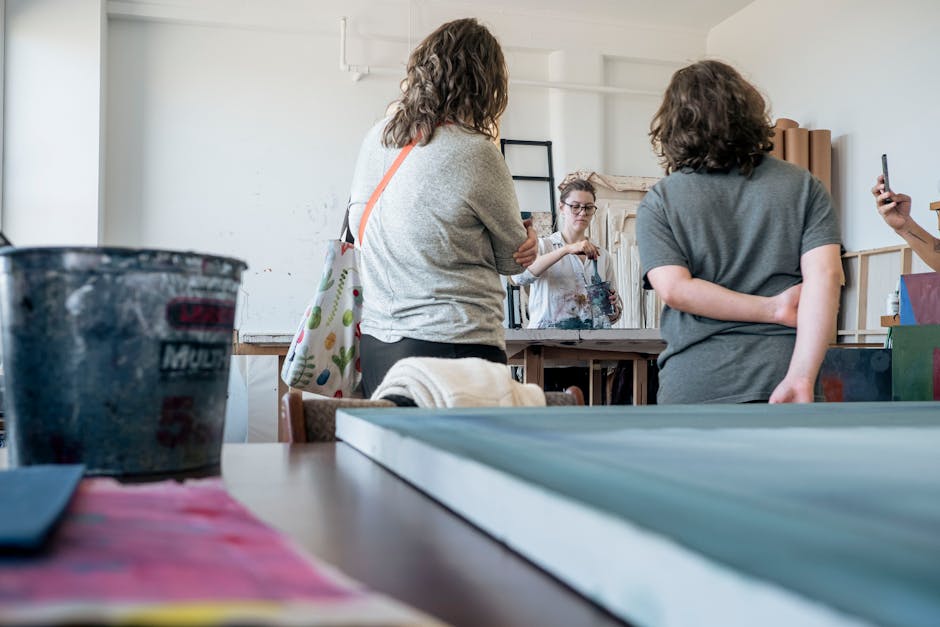 A close-up view of an art class with students learning from a teacher.